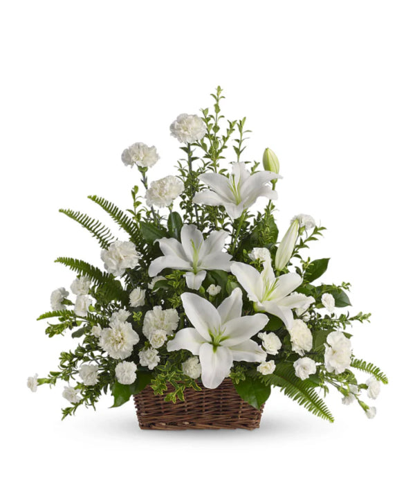 Peaceful white lilies flower arrangement in a basket